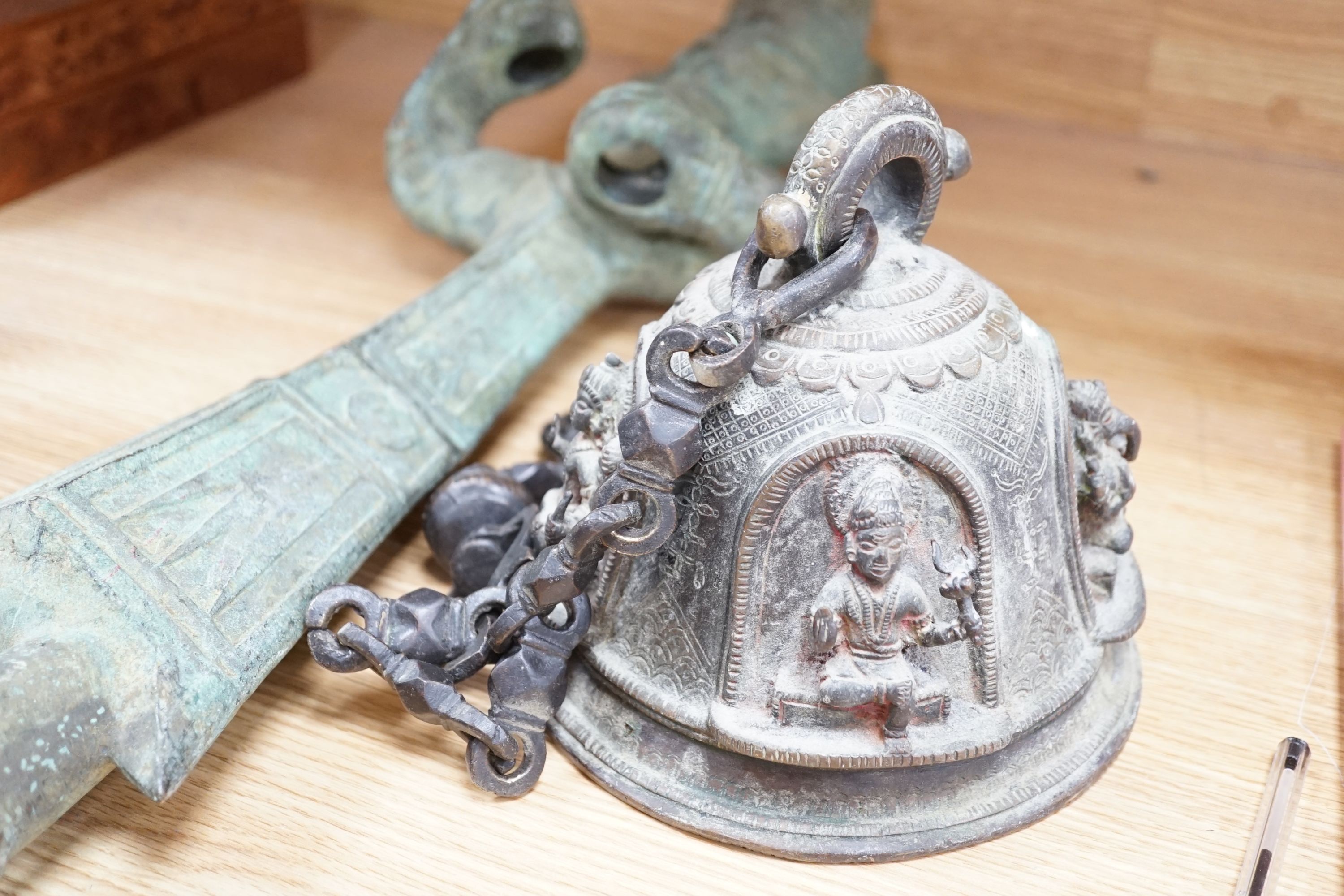 A large, archaic tic bronze figure, 76cm, and a bronze bell on chain